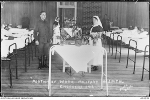A section of a ward in the 13th Australian General Hospital at Enoggera. From left to right are: Private W Temple, Sister R A Skyring (left rear) and Sister Homewood. Bed patients are on both sides of the ward. http://www.awm.gov.au/collection/A03239/